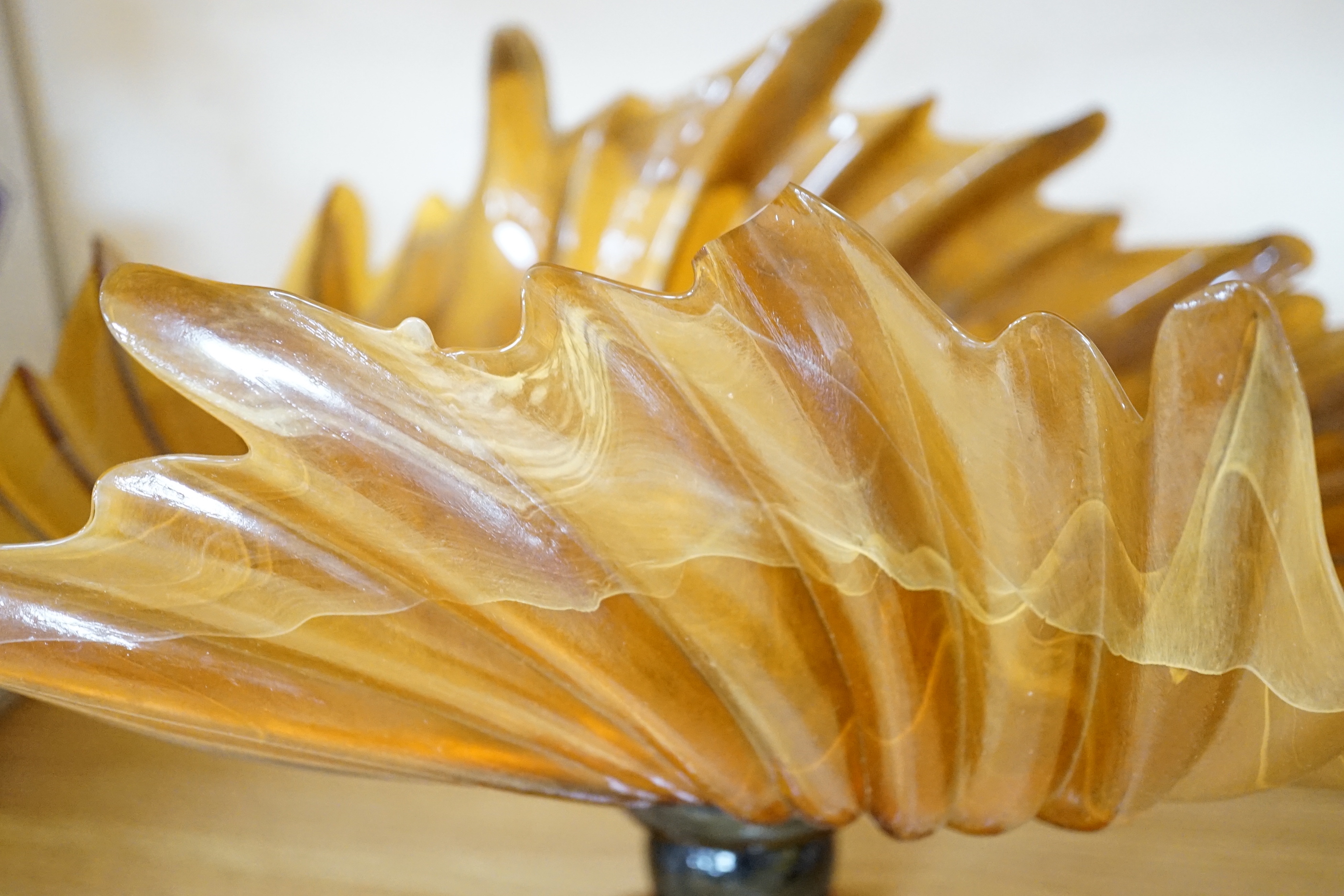 Two amber glass frilled table centrepieces, one with Murano label to the base and a pair of similar leaf shaped dishes (4), the largest 48cm wide